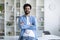 Modern Entrepreneur. Handsome Young Indian Man Standing With Folded Arms Near Desk