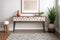 modern entryway with geometric patterned rug and a console table