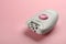 Modern epilator on pink background, space for text