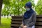 Modern european muslim woman wearing surgical face mask praying digital tespih in the park