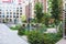 Modern european residential apartment complex yard territory, multi-story house buildings with playground and benches,