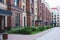 Modern european residential apartment complex yard territory, multi-story house buildings with playground and benches,