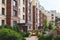 Modern european residential apartment complex yard territory, multi-story house buildings with playground and benches,