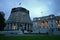 Modern expansion of conic Beehive in gray concrete to old Edwardian parliament illuminated at dusk, Wellington, New Zealand