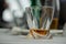 Modern fancy whiskey glass with golden alcoholic beverage on a white tablecloth surface as a symbol of drinking alcohol