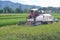 Modern farmers use vehicles equipped with rice-cutting machine tools when harvesting