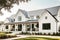 modern farmhouse exterior with fresh paint, sleek metal roof and wrap around porch