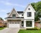 A modern farmhouse home with a white and brick exterior.