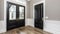 a modern farmhouse interior design house, adorned with single panel black interior doors, accented by gold hardware, and