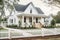 modern farmhouse with wrap-around porch, picket fence and garden