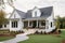 modern farmhouse with wrap-around porch, welcoming guests to stop by for a visit