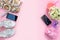 Modern fashion accessories young women shoes handbag phone gadget lipstick cosmetics bouquet flowers pink background.