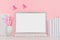 Modern fashion workplace - silver laptop with blank screen, white stationery, stickers magnet on soft pink background.