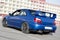 a modern fast race sport blue car on the track on summer practice day