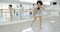 Modern female dancer in bright studio practicing