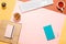 Modern feminine home workspace. Flat lay composition of keyboard, cactus, diary with pen and cup of tea on colorful desk