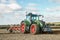 Modern fendt tractor pulling a plough