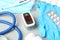 Modern fingertip pulse oximeter and medical items on grey stone background