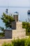 Modern fireplace grill chimney with sea and boats in background.