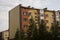 Modern five-storeyed house with flats. It was colored in red, orange and white colors