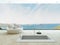 Modern floor bathtub against huge window with seascape view