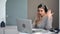 Modern freelancer woman in headphones talking online video call laptop. Medium shot on RED camera