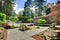 Modern front yard landscape with walkways and rocks.