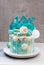 Modern Frozen theme cake decorated with blue caramel, white chocolate, fondant snowflakes, macaroons and meringue