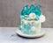 Modern Frozen theme cake decorated with blue caramel, white chocolate, fondant snowflakes, macaroons and meringue