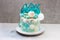 Modern Frozen theme cake decorated with blue caramel, white chocolate, fondant snowflakes, macaroons and meringue