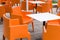 Modern furniture outdoor cafe terrace with orange chairs