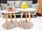 modern furniture, two white mini tables with brown wooden table legs, gray chairs as background.