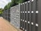 Modern gabion wall system with stones as element of garden wooden metal fence