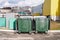 Modern garbage containers with garbage in a residential area. Environmental problem of processing and disposal of solid