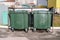 Modern garbage containers with garbage in a residential area. Environmental problem of processing and disposal of solid