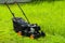 Modern gasoline powered grass mower on grass