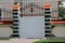 Modern gates framed by marble columns.