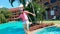 Modern girl dances near pools at a resort.