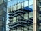 Modern glass curtain wall building facade with strong reflections. office tower mirrored in the glass