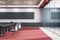Modern glass meeting or conference room interior with furniture, red carpet and blank wide black mock up banner on wall. 3D