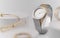 Modern golden and silver wrist watch between golden accessories