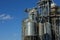 Modern grain terminal. Metal tanks of elevator. Grain-drying complex construction. Commercial grain or seed silos at