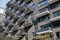 Modern gray apartment building with many balconies