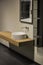 Modern gray and beige bathroom with wooden cabinet, round basin and mirror