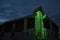 Modern Green-lit Church at Twilight with Red Accents