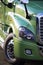 Modern green rig semi truck details like fency big transport