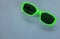 Modern green sunglasses isolate on a gray background.Traveler and summer accessories