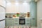 Modern green-teal kitchen interior, furniture front view