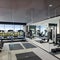 A modern gym with mirrored walls, exercise equipment, and a dedicated area for yoga and stretching4, Generative AI