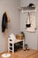 Modern hallway interior with shoe rack and wooden coat stand